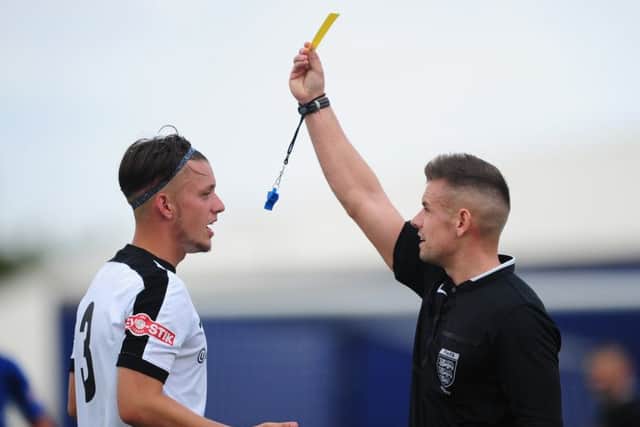 Corby's Liam Marshall is shown a yellow card during the 0-0 draw with Matlock