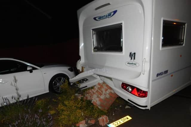 The caravan rolled into a brick wall and a neighbour's car.