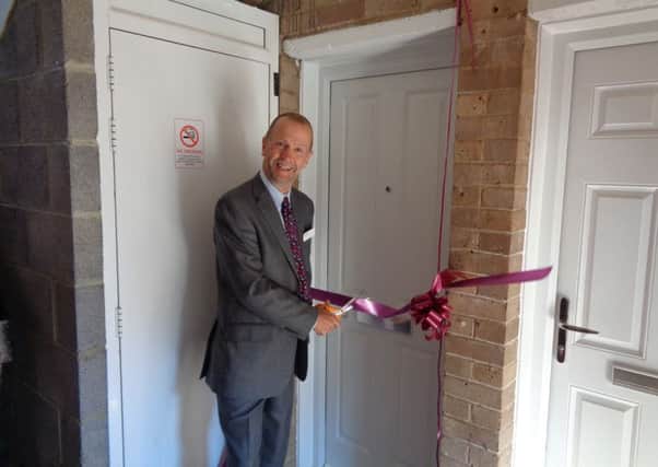 Cllr Burton officially opens one of the new properties.