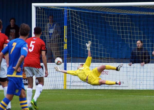 Paul Walker is beaten by George Hallahan's penalty, which gave Basingstoke Town their second goal in the 3-0 win over Kettering Town. Pictures by Peter Short