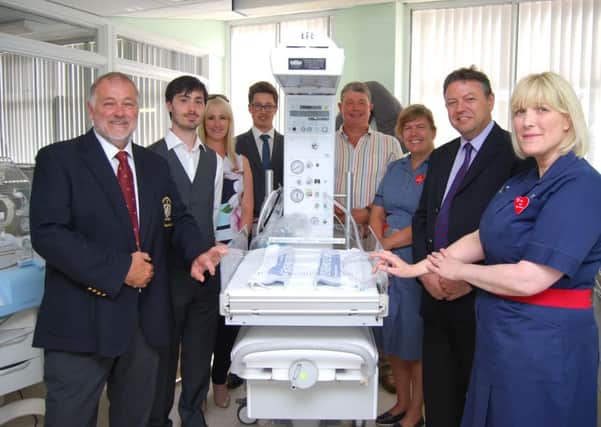 Golf club members and hospital staff with the new device.