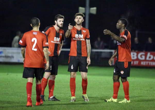 Paul Malone discusses things with his new Kettering Town team-mates during his debut for the Poppies on Tuesday night. Picture by Alison Bagley