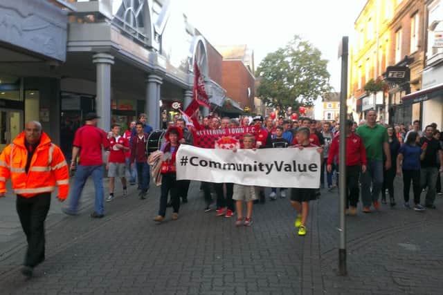 Poppies fans march through the town centre.
