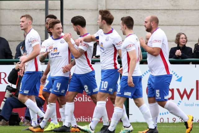 Jack Ashton takes the congratulations after scoring AFC Rushden & Diamonds' winner against Coalville Town. Pictures by Alison Bagley
