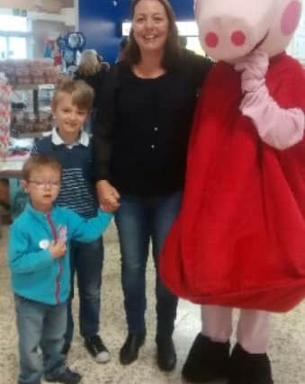 Sam with brother Matthew, mum Sarah and Peppa Pig.