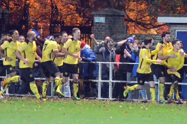 AFC Rushden & Diamonds' players and fans celebrate Jack Ashton's winner at Spalding United on Tuesday night. Picture by Tim Wilson
