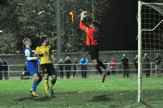 Goalkeeper Ben Heath catches a cross during his debut for AFC Rushden & Diamonds at Spalding on Tuesday. Picture by Tim Wilson