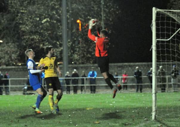 Goalkeeper Ben Heath catches a cross during his debut for AFC Rushden & Diamonds at Spalding on Tuesday. Picture by Tim Wilson