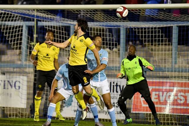 Brad Harris goes up for an aerial challenge during AFC Rushden & Diamonds' 1-1 draw at Rugby Town. Picture by Martin Pulley