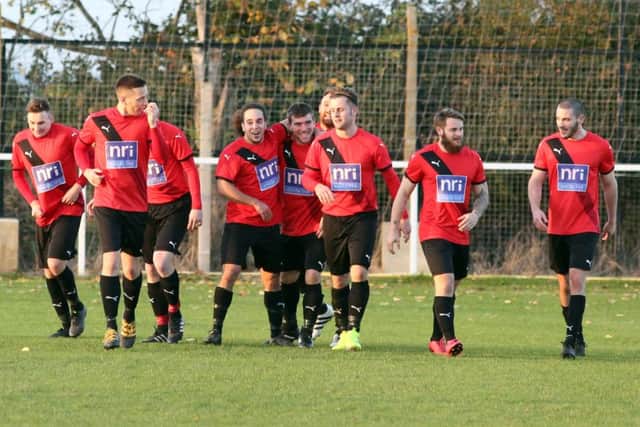 Irchester celebrate after one of their goals in the 7-0 hammering of Woodford