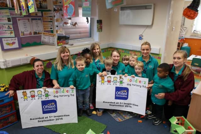 Staff and children at the nursery celebrate.