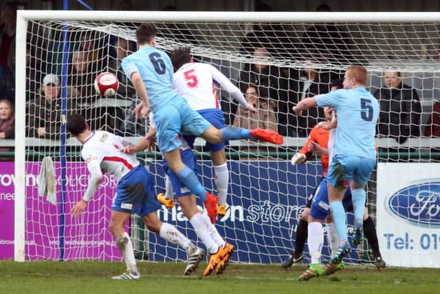 James Blunden (No.6) heads home Lincoln United's second goal
