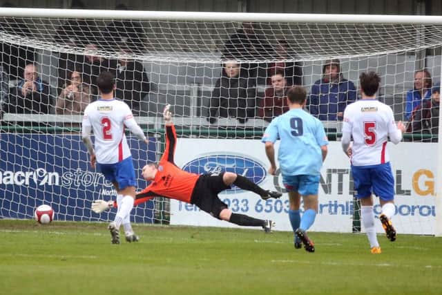 Lincoln United's Jordan Hempenstall scores his team's opening goal at the Dog & Duck