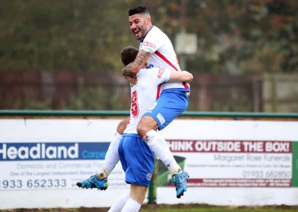 Lewis Leslie celebrates with corner taker Nic Evangelinos after the midfielder headed home AFC Rushden & Diamonds' first equaliser in the 3-3 draw with Lincoln United in the FA Trophy. Pictures by Alison Bagley