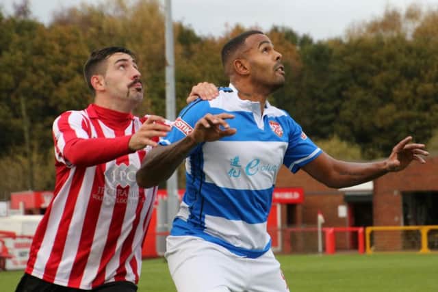 Poppies striker Matthew Barnes-Homer and a Witton defender keep their eye on the ball