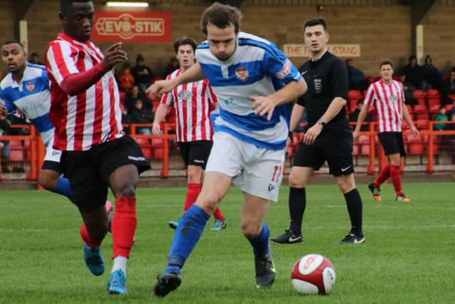 James Brighton gets on the ball for the Poppies but was forced off with an injury during the defeat at Witton