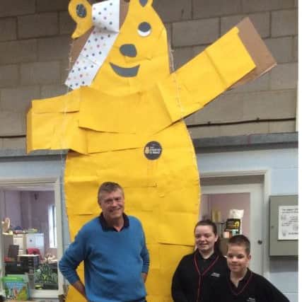 John Akers with two pupils from Friars School in Wellingborough