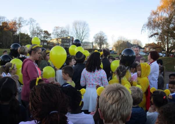 Children get ready to release their balloons.