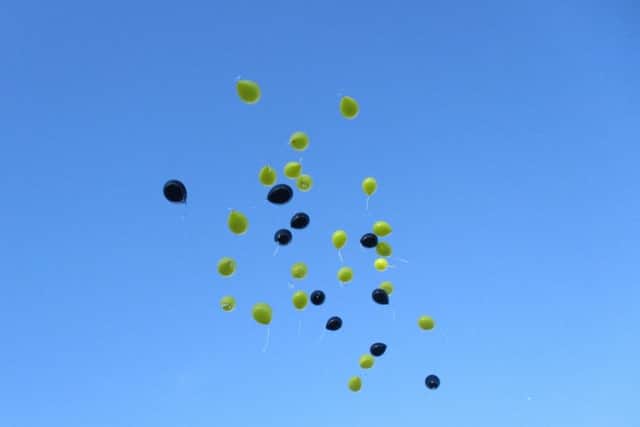 The balloons in the sky.