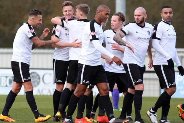 The Corby players celebrate Jamie Tank's goal against Ashton