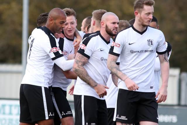 Jamie Tank takes the congratulations after he opened the scoring for Corby Town in their 3-3 draw with Ashton United. Pictures by Alison Bagley