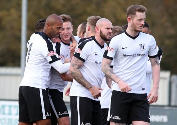 Jamie Tank takes the congratulations after he opened the scoring for Corby Town in their 3-3 draw with Ashton United. Pictures by Alison Bagley