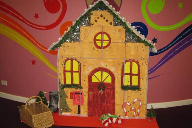 All the items are being left next to a gingerbread house advent calendar made by school display assistant Emily Brealey
