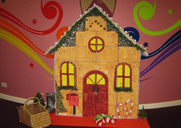All the items are being left next to a gingerbread house advent calendar made by school display assistant Emily Brealey