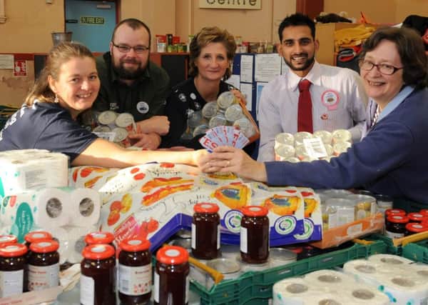 Tesco staff handing over the vouchers and donations for the food bank