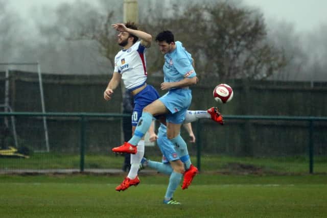 Tom Lorraine, who scored Diamonds' goal, challenges for a header during the draw with Lincoln United