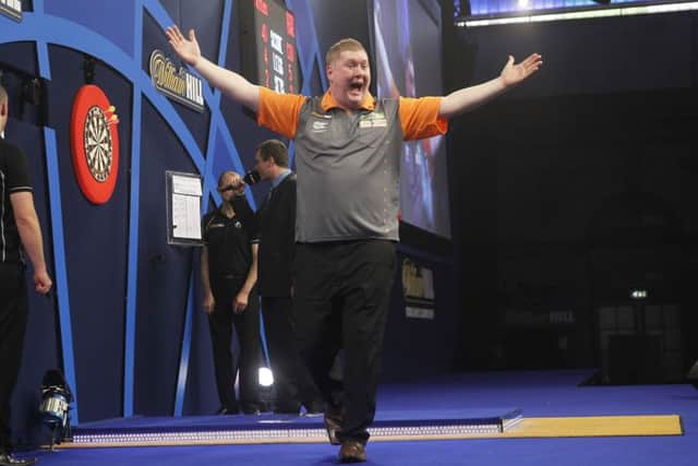 Ricky Evans, pictured celebrating his win over Simon Whitlock last year, is preparing for another appearance in the PDC World Championship