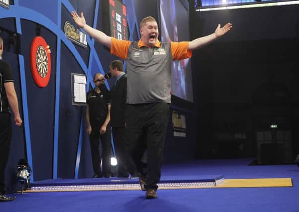 Ricky Evans, pictured celebrating his win over Simon Whitlock last year, is preparing for another appearance in the PDC World Championship