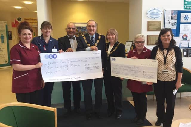 Cllr Waters and wife Veronica handing over the cheques last week