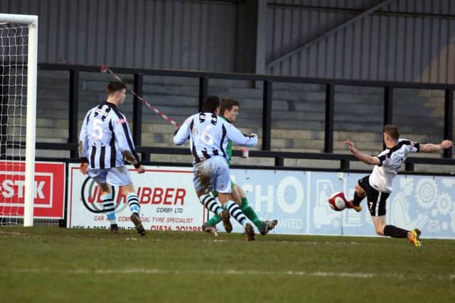 Connor Kennedy stretches for the ball with one of Corby's first-half chances