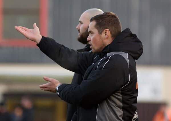 Gary Mills and David Bell give out the instructions during Corby Town's 3-1 defeat to Workington at Steel Park. Pictures by Alison Bagley