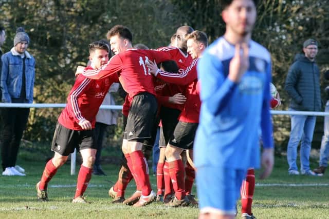 Rothwell Corinthains celebrate after Callum Plowright's penalty earned them a 1-1 draw with local rivals Desborough Town. Pictures by Alison Bagley