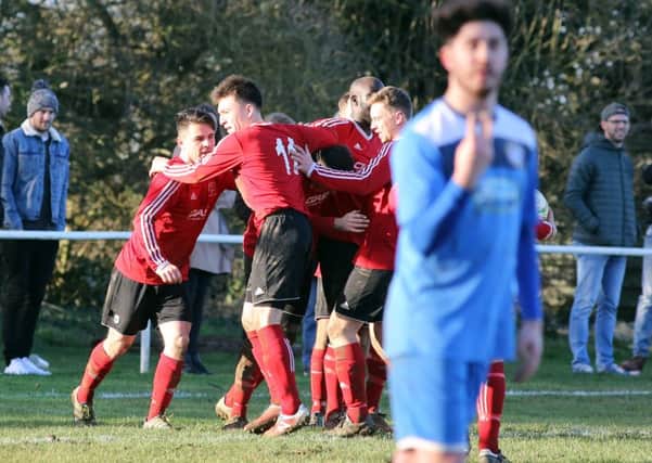 Rothwell Corinthains celebrate after Callum Plowright's penalty earned them a 1-1 draw with local rivals Desborough Town. Pictures by Alison Bagley