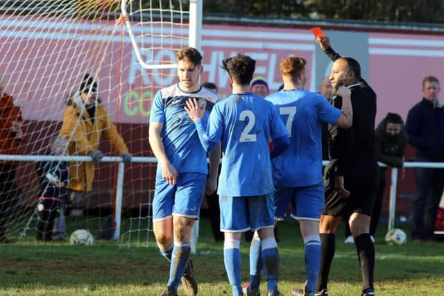 Desborough's Leo Adams is sent-off for his deliberate handball, which resulted in a penalty for Rothwell Corinthians