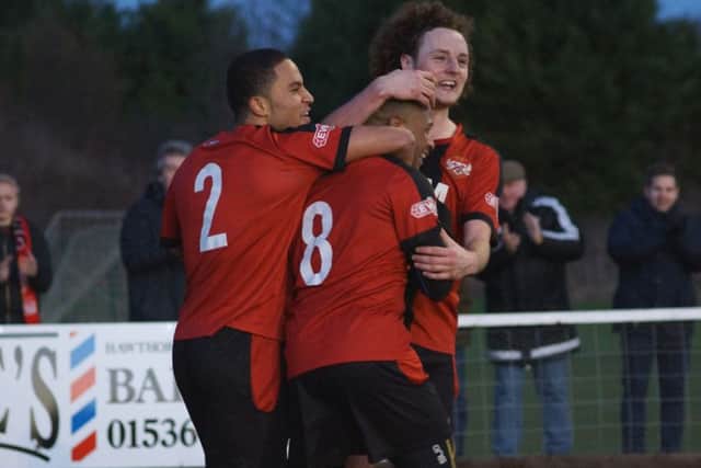 Aaron O'Connor is congratulated by Liam Canavan and Nathan Hicks after scoring Kettering Town's goal in the 1-1 draw with King's Lynn Town at Latimer Park. Pictures by Peter Short
