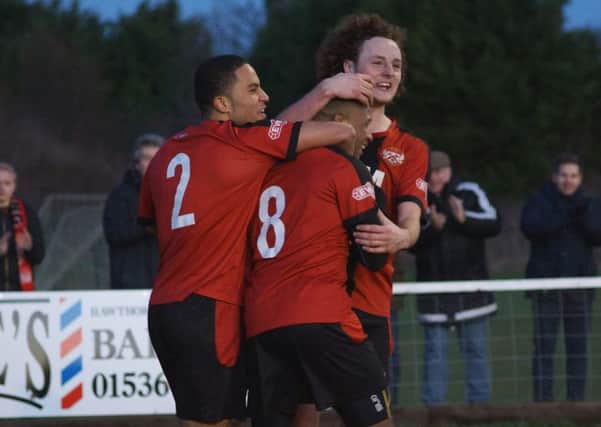 Aaron O'Connor is congratulated by Liam Canavan and Nathan Hicks after scoring Kettering Town's goal in the 1-1 draw with King's Lynn Town at Latimer Park. Pictures by Peter Short