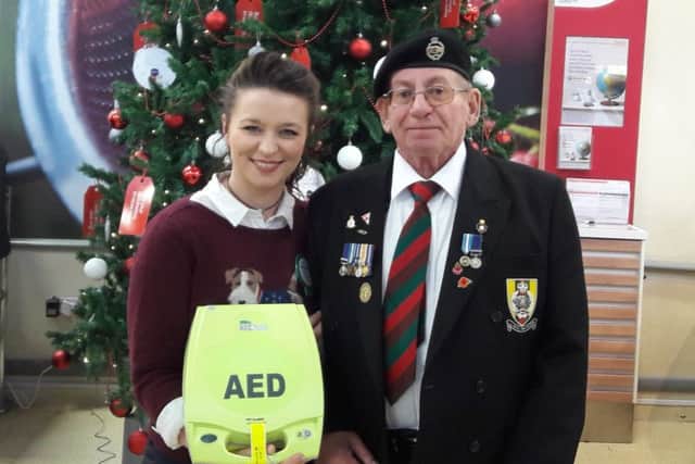 Georgina and Alan with the life-saving defibrillator.