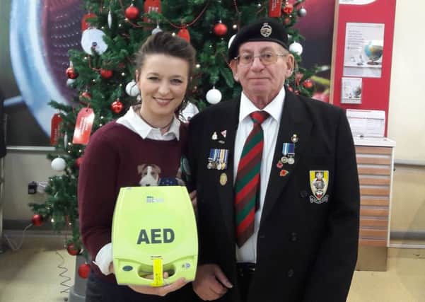 Georgina and Alan with the life-saving defibrillator.
