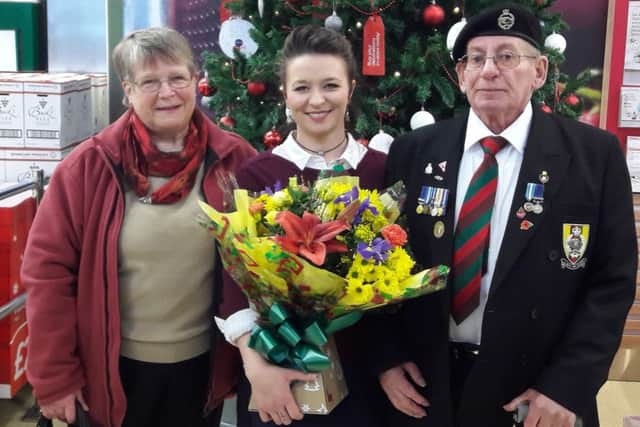 Georgina is given flowers by Alan and his wife Janet.