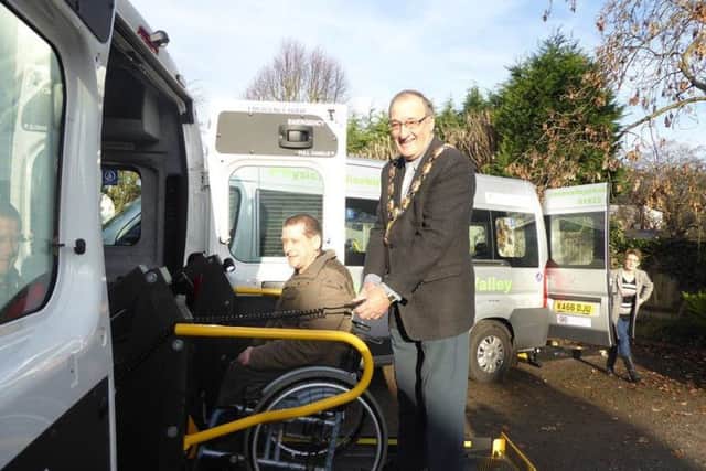 Wellingborough mayor Malcolm Waters helping out with the new minibuses