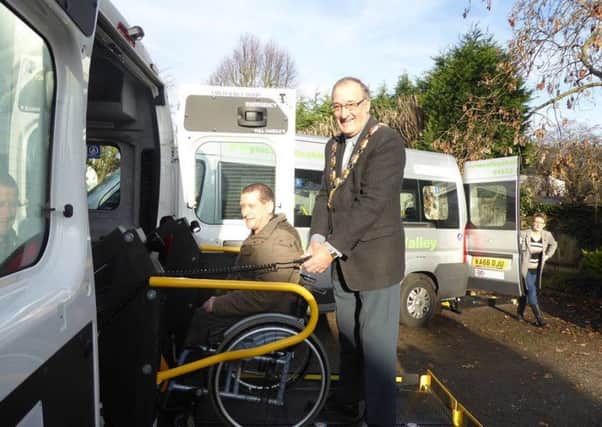 Wellingborough mayor Malcolm Waters helping out with the new minibuses