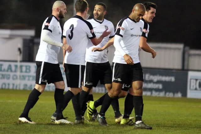Stefan Moore takes the congratulations after scoring the first of his two goals in Corby Town's 3-1 victory over Spennymoor Town at Steel Park. Pictures by Alison Bagley