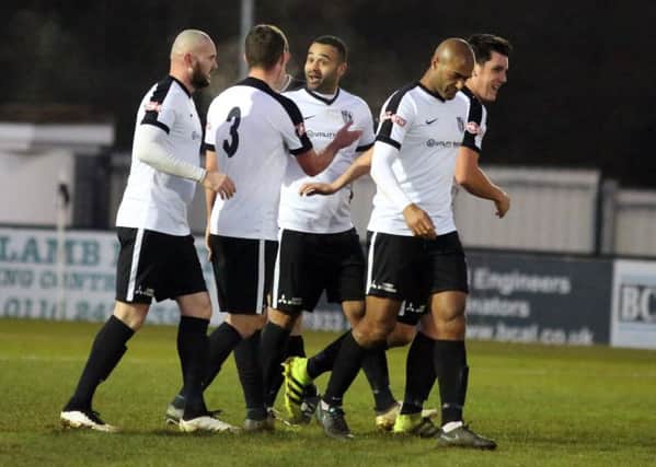 Stefan Moore takes the congratulations after scoring the first of his two goals in Corby Town's 3-1 victory over Spennymoor Town at Steel Park. Pictures by Alison Bagley