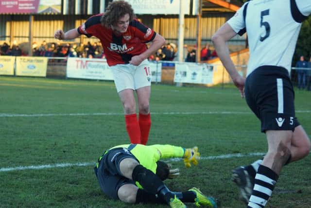 Liam Canavan scores the Poppies' first goal at Cambridge
