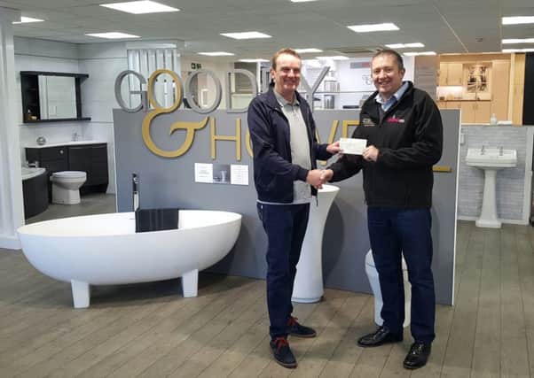 Karl Howell from Goodey & Howell and Plumbco handing over the cheque to Graham Campbell from Glamis Hall