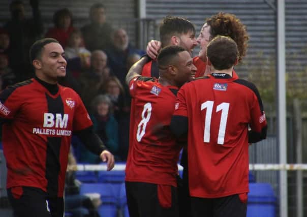 Paul Malone takes the congratulations after opening the scoring in Kettering Town's 2-1 success over Basingstoke Town at Latimer Park. Pictures by Peter Short